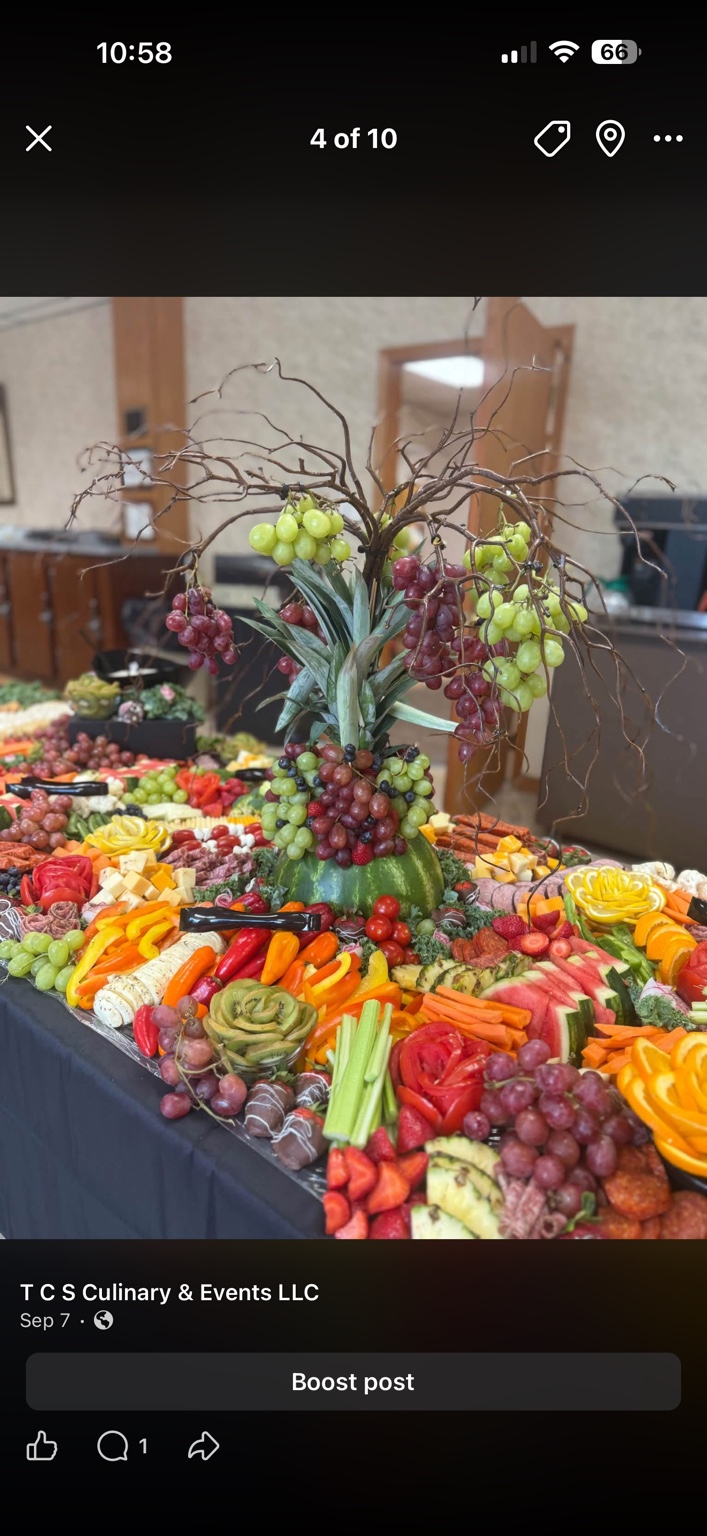 Grazing table centerpiece with pineapple, hanging grapes and assorted food platters