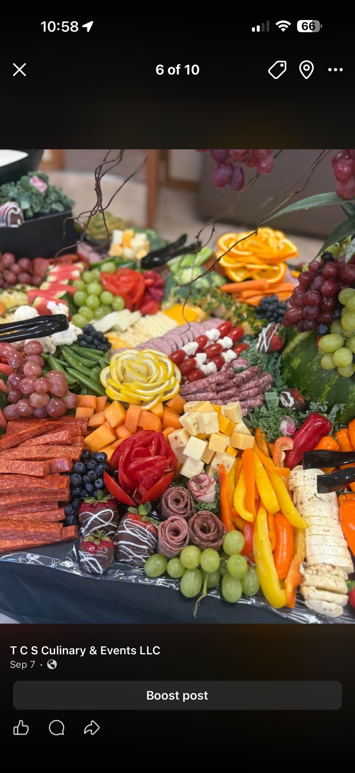 Meats, cheeses, fruit, vegetables and decorative citrus on a grazing table