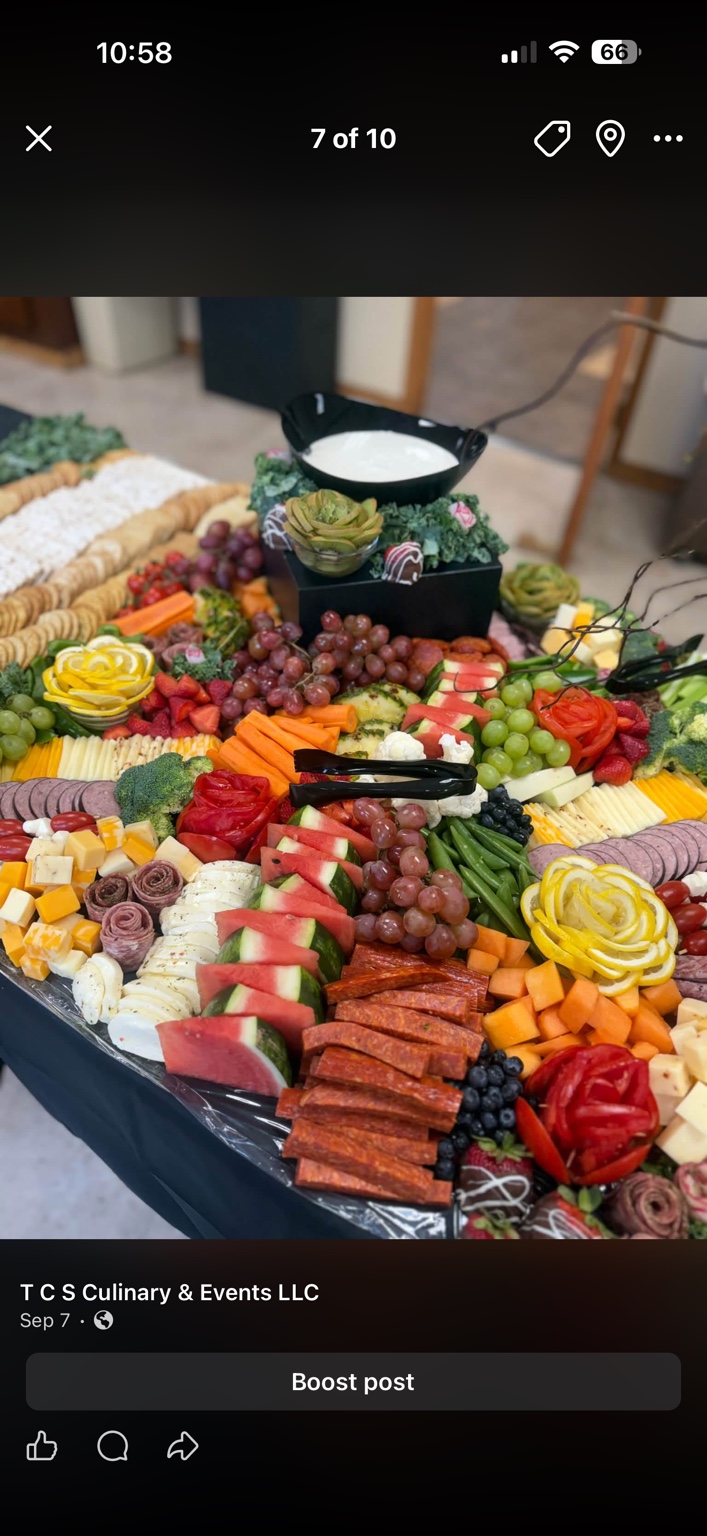 Catering spread with fruit, vegetables, cheeses, meats, crackers and dips