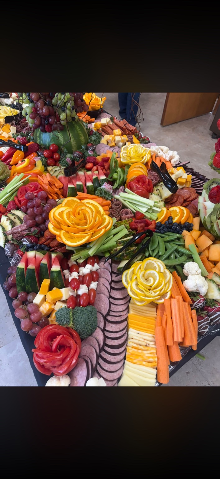 Grazing table with meats, cheeses, vegetables, fruit and citrus garnishes